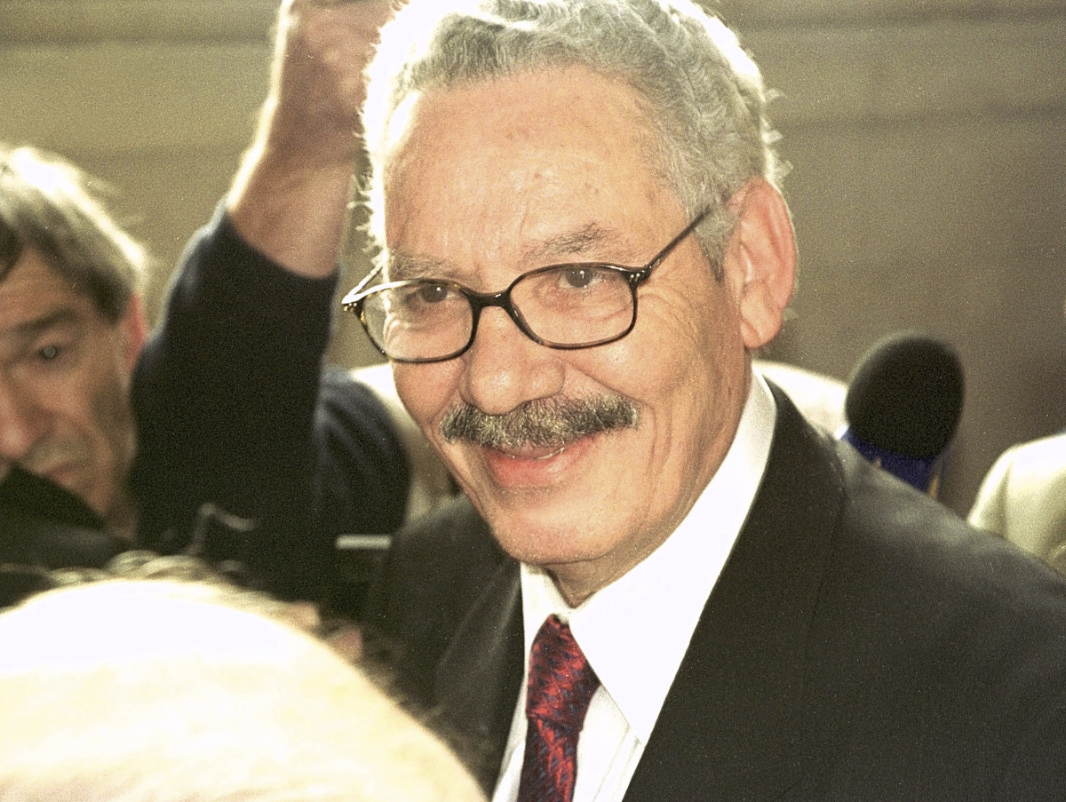 Former Algerian Defense Minister and retired Gen. Khaled Nezzar smiles as he answers reporters at the Paris courthouse Monday, July 1, 2002. (AP)
