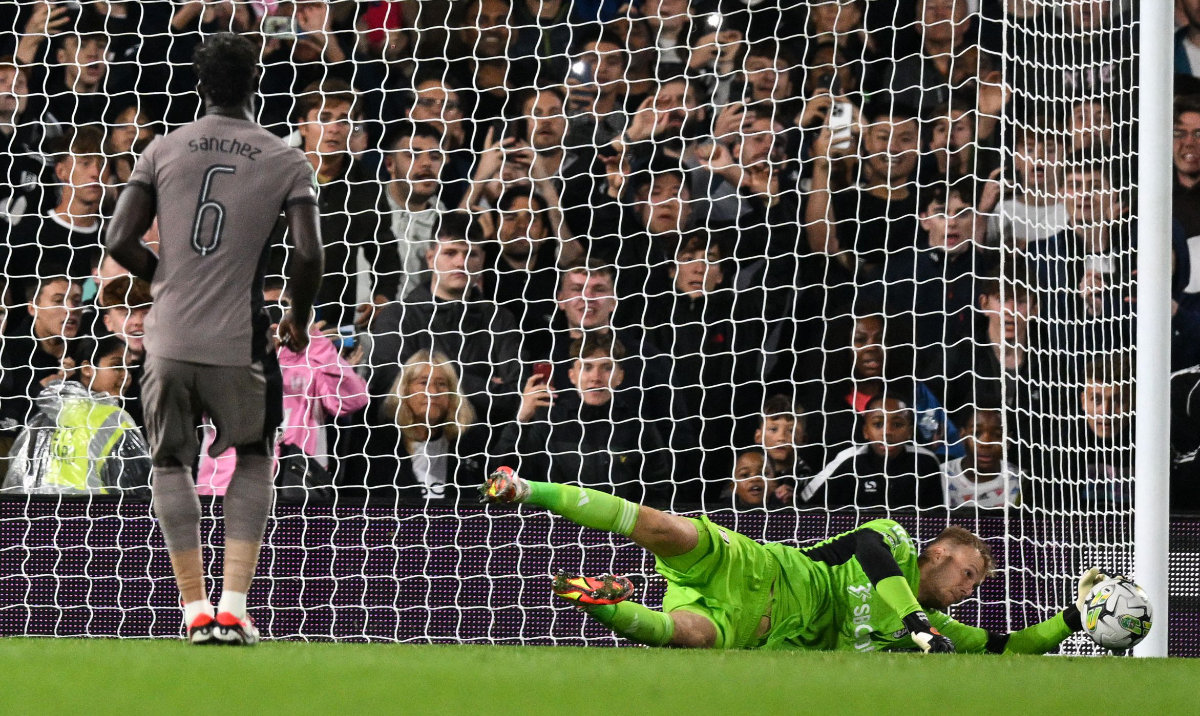 Fulham's Slovakian goalkeeper Marek Rodak saves the penalty shot by Tottenham Hotspur's Colombian defender Davinson Sanchez during the English League Cup match between Fulham and Tottenham Hotspur at Craven Cottage stadium, in London, on Tuesday. (AFP)
