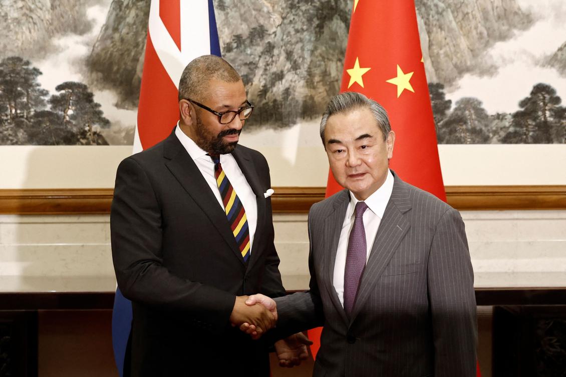 British Foreign Secretary James Cleverly (L) and Chinese Foreign Minister Wang Yi shake hands before a meeting at the Diaoyutai State Guesthouse in Beijing. (AFP)