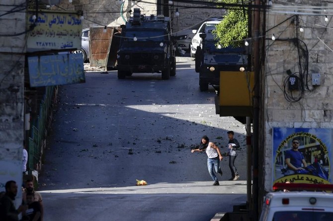 Palestinians clash with own security forces in a West Bank refugee camp, leaving 1 dead