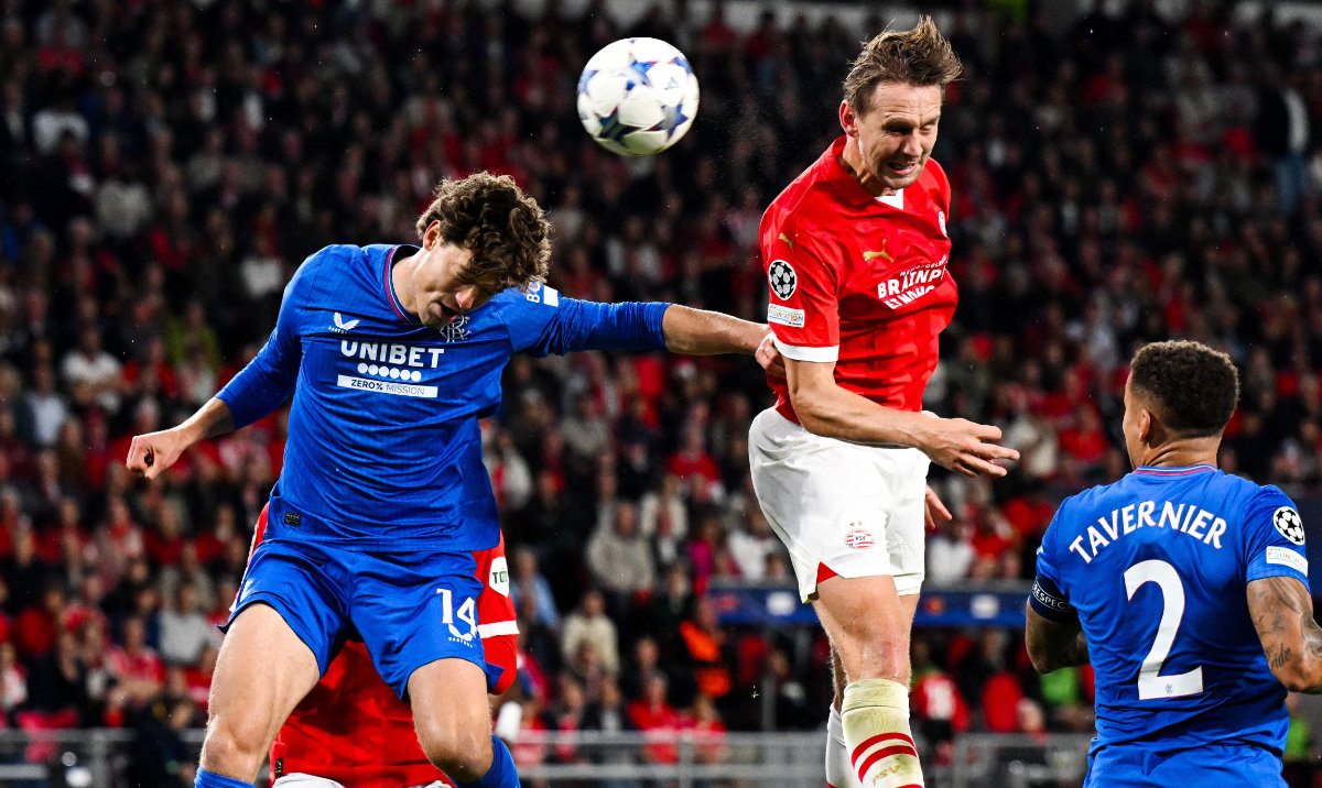 PSV Eindhoven's Dutch forward Luuk de Jong (C) heads the ball to score his team's third goal during the UEFA Champions League play-off football match between PSV Eindhoven and Rangers FC at The Phillips stadium in Eindhoven on Wednesday. (AFP)