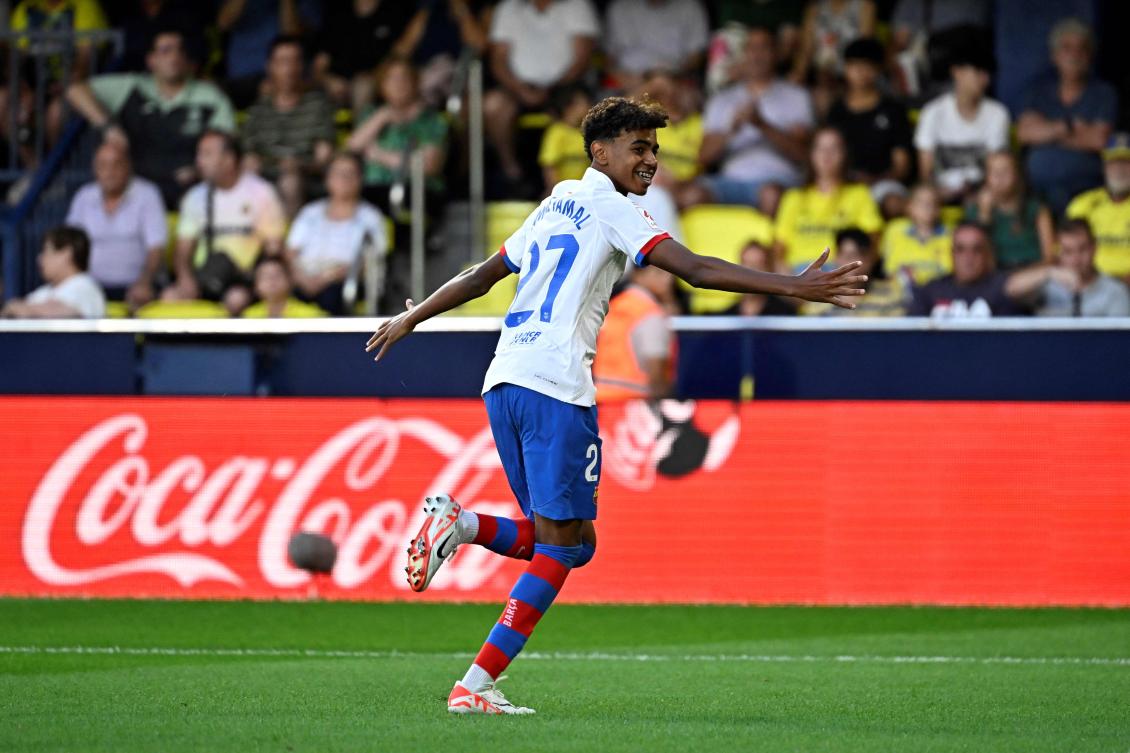 Barcelona’s Spanish forward Lamine Yamal celebrates after Barcelona’s Polish forward Robert Lewandowski scored during their Spanish Liga match against Villarreal CF at La Ceramica stadium in Vila-real on Aug. 27, 2023. (AFP)
