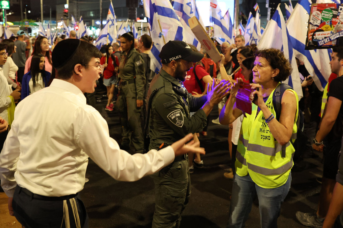An Ultra-Orthodox Jewish man shouts at a woman during an anti-discrimination protest in Israel. (AFP)