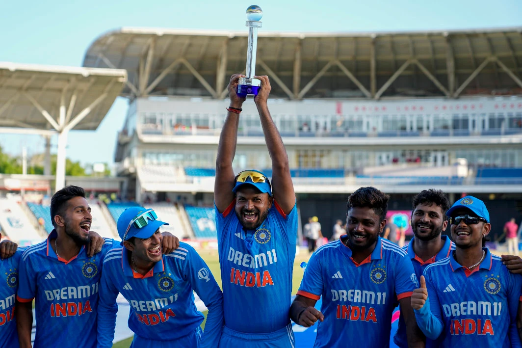 India's Mukesh Kumar hoists the trophy after India defeated West Indies for 200 runs in their third ODI cricket match to win the series 2-1 at the Brian Lara Stadium in Tarouba, Trinidad and Tobago, Wednesday. (AP)