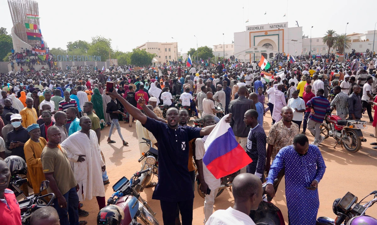 Nigeriens, some holding Russian flags, participate in a march called by supporters of coup leader Gen. Abdourahmane Tchiani in Niamey, Niger, Sunday, July 30, 2023. (AP/File)