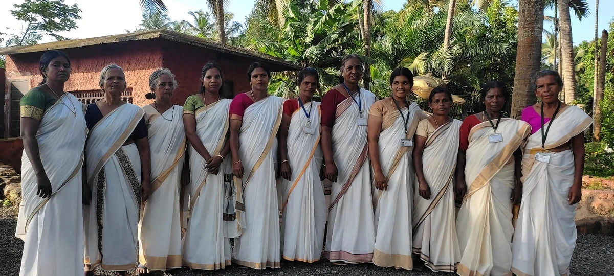 Eleven sanitation workers who hit the jackpot of $1.2 million pose for a photo in Parappanangadi, Kerala, in July 2023. (M.P. Radha)