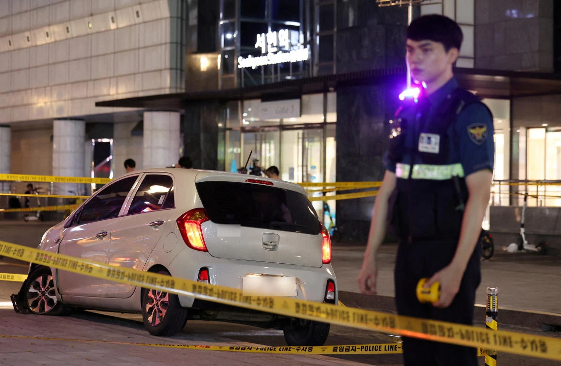 A policeman stands next to a scene where, according to media reports, nine people have been stabbed and four others hurt by a car driven by the suspected attacker in Seongnam, South Korea, August 3, 2023. (Reuters)