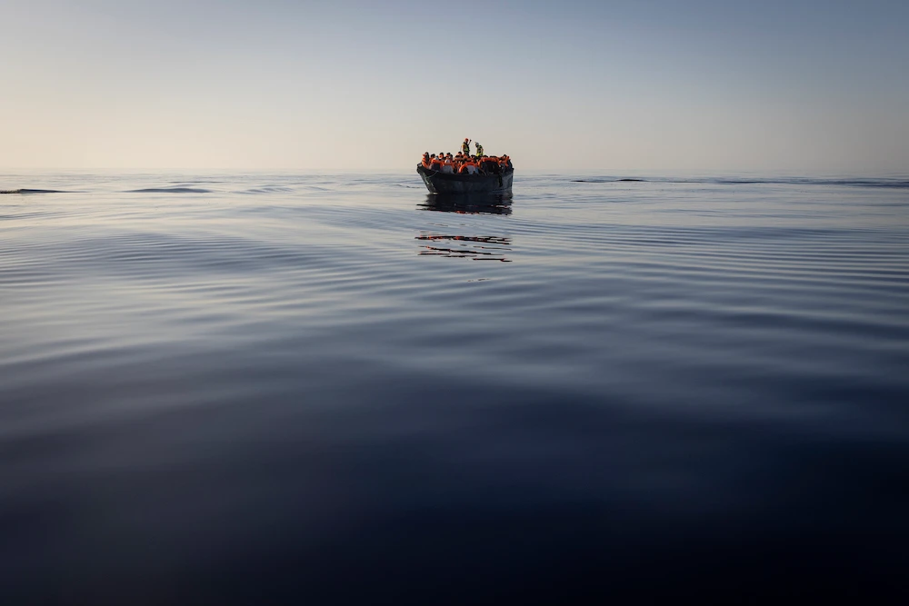 Migrants with life jackets provided by volunteers of a migrant search and rescue group as they are being rescued on Aug. 27, 2022 in the Mediterranean sea. (AP)
