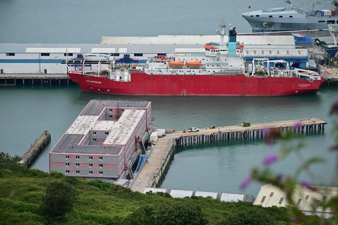 The Bibby Stockholm accommodation barge (L) is pictured moored to the quayside at Portland Port in Portland, on the south-west coast of England on August 7, 2023. (AFP)