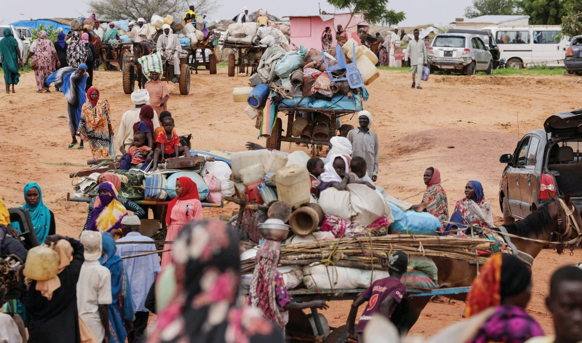 Chadian cart owners transport belongings of Sudanese people who fled the conflict in Darfur region. They were crossing the border between Sudan and Chad. (Reuters/File)