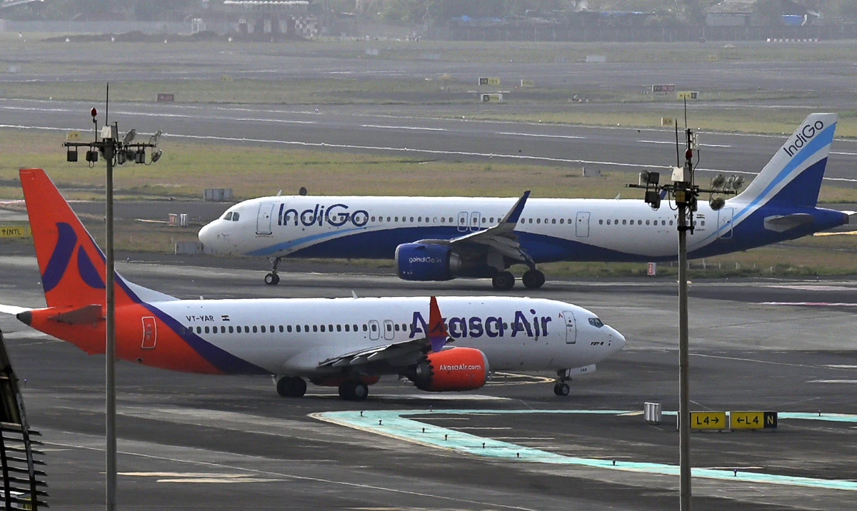 An IndiGo airlines aircraft (back) taxies in the apron at the Mumbai International airport in Mumbai, India on June 20, 2023. (AFP)