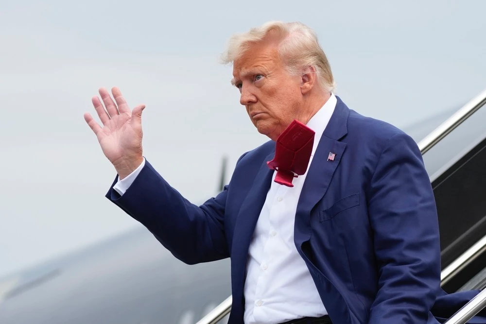 Former President Donald Trump waves as he steps off his plane at Ronald Reagan Washington National Airport. (AP/File)