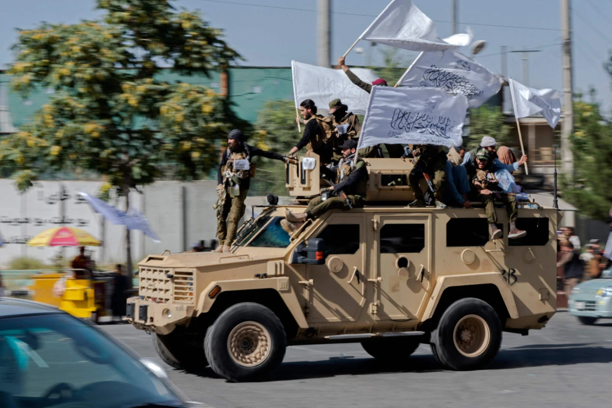 Armed Taliban security personnel ride a vehicle convoy as they parade near the US embassy in Kabul on August 15, 2023, during the second anniversary celebrations of their takeover. (AFP)