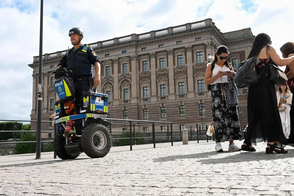 A police officer on a Segway patrols at Sweden’s parliament Riksdagen as the terror threat level in Sweden was raised to four on a five-point scale on Aug. 17, 2023. (AFP)