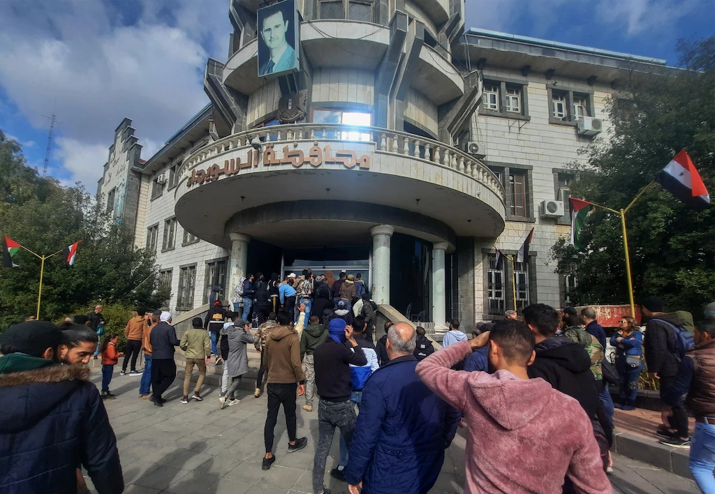 A file photo of demonstrators rallying to protest deteriorating living conditions in front of the Suwaida governorate building in the eponymous southern Syrian city, on December 4, 2022. (AFP)