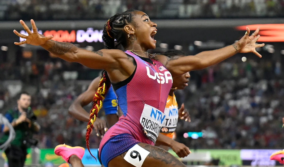 Sha'Carri Richardson, of the US, spreads her arms as he crosses the line to win gold in the women's 100 meter final during the World Athletics Championships in Budapest Monday. (AP)
