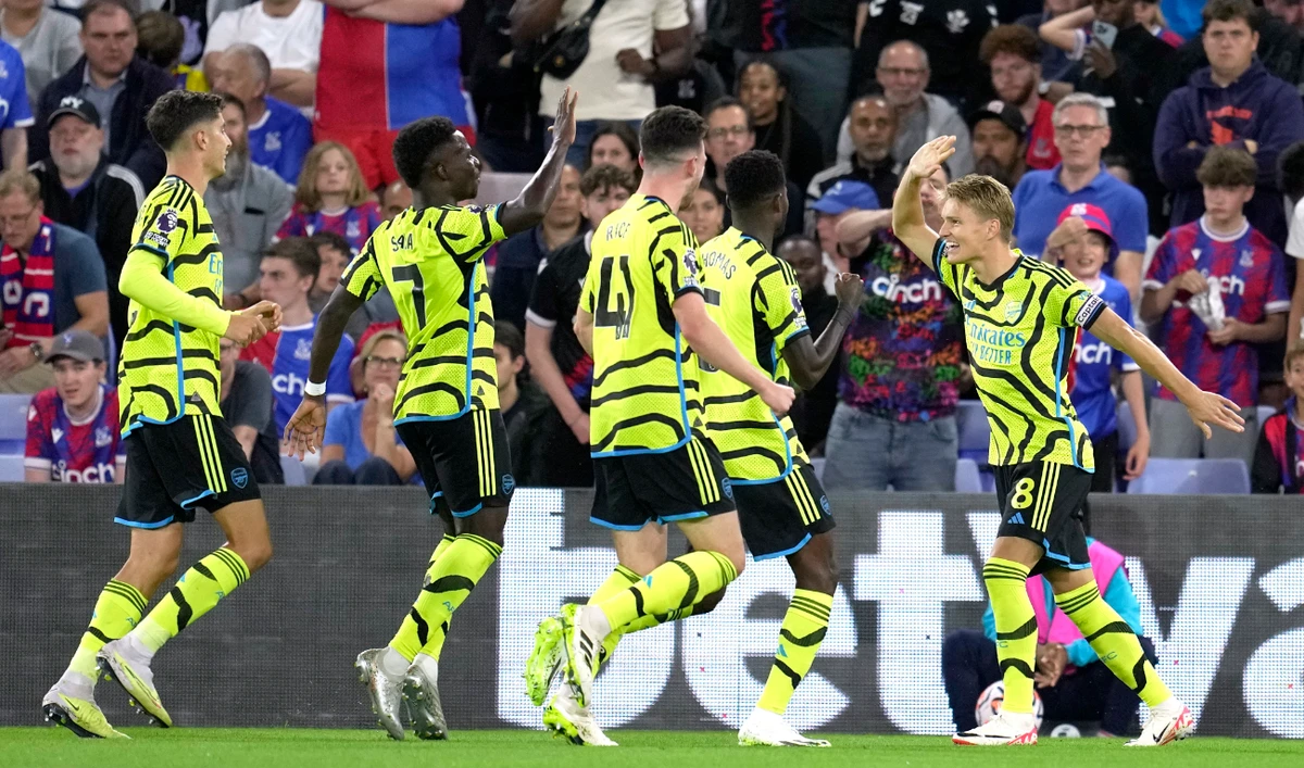 Arsenal’s Martin Odegaard, right, celebrates after scoring the opening goal during the Premier League soccer match between Crystal Palace and Arsenal at Selhurst Park, in London Monday. (AP)