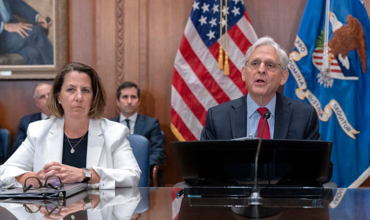 Attorney General Merrick Garland accompanied by Deputy Attorney General Lisa Monaco speaks during a meeting at Department of Justice in Washington, June 14, 2023. Hundreds of people have been charged with the theft of more than $830 million in COVID-19 emergency aid following a nationwide operation conducted by federal, state and local law enforcement agencies, the US Justice Department announced Wednesday. (AP)