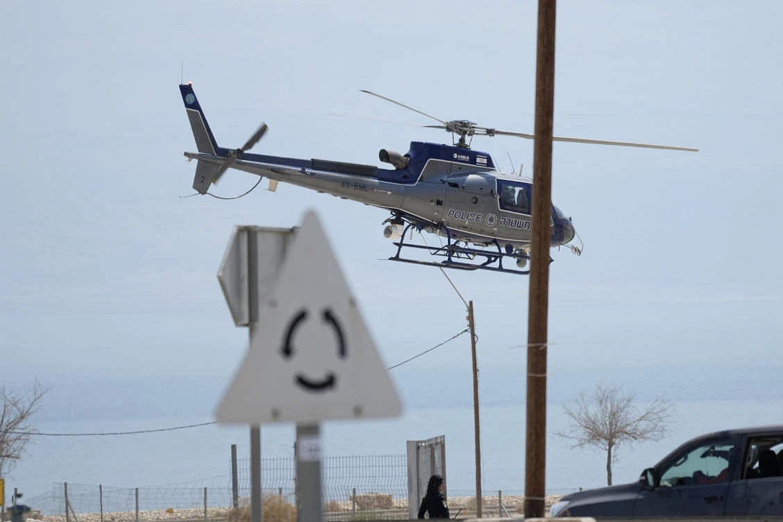 An Israeli police helicopter works at the site of a rockslide that took place in the Ein Gedi Nature Reserve, on the western shore of the Dead Sea, a popular tourist site in Israel, Thursday, Aug. 24, 2023. An avalanche of rock tumbled down a hillside near the Dead Sea, Israeli medics said, injuring several people. (AP Photo)