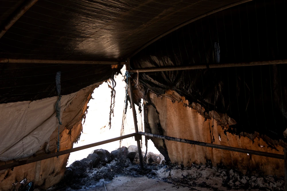 Above, a razed tent in the West Bank Palestinian Bedouin village of Al-Qabun after residents fleeing from Israeli settler violence burned most of the items they could not carry. (AP)