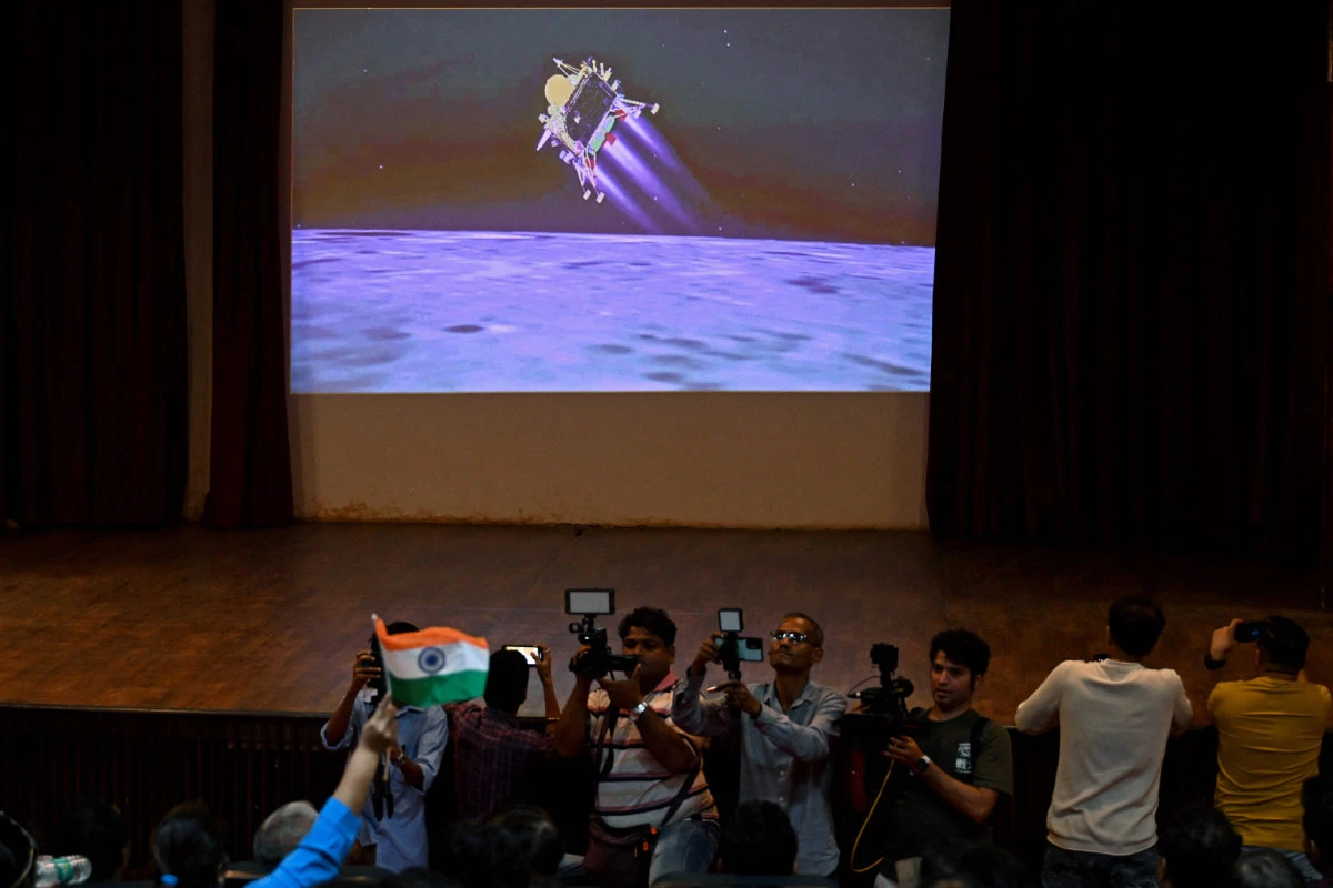 People watch a live stream aired by Indian Space Research Organization (ISRO) website at the Nehru Science Centre in Mumbai on August 23, 2023, minutes before the successful lunar landing of Chandrayaan-3 spacecraft on the south pole of the Moon. (AFP)