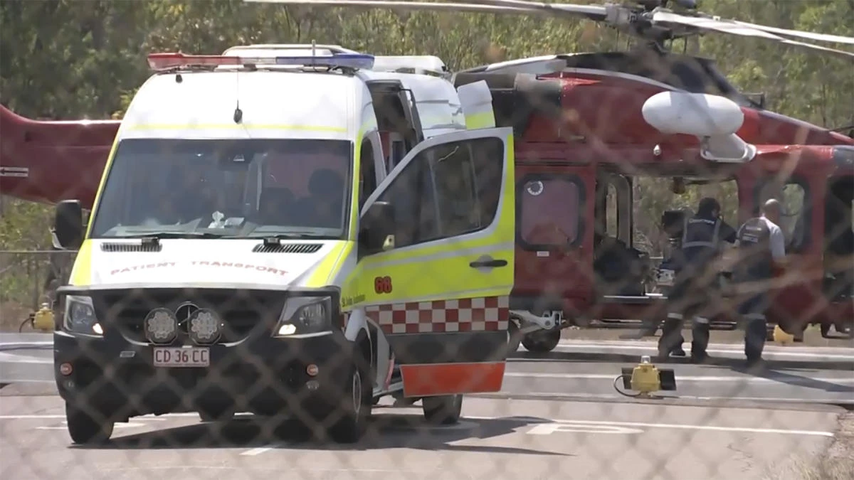 Above, a helicopter and ambulance being used in the medical transport of those involved in the aircraft crash, in Darwin, Australia on Aug. 27, 2023. (AuBC via AP)
