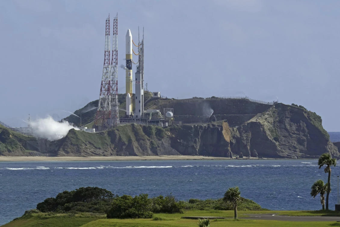 An H2A rocket sits at launch pad at Tanegashima Space Center in Kagoshima, southern Japan on Aug. 28, 2023. The rocket was to blast off Monday morning, but the lift-off was postponed due to strong winds. (Kyodo News via AP)