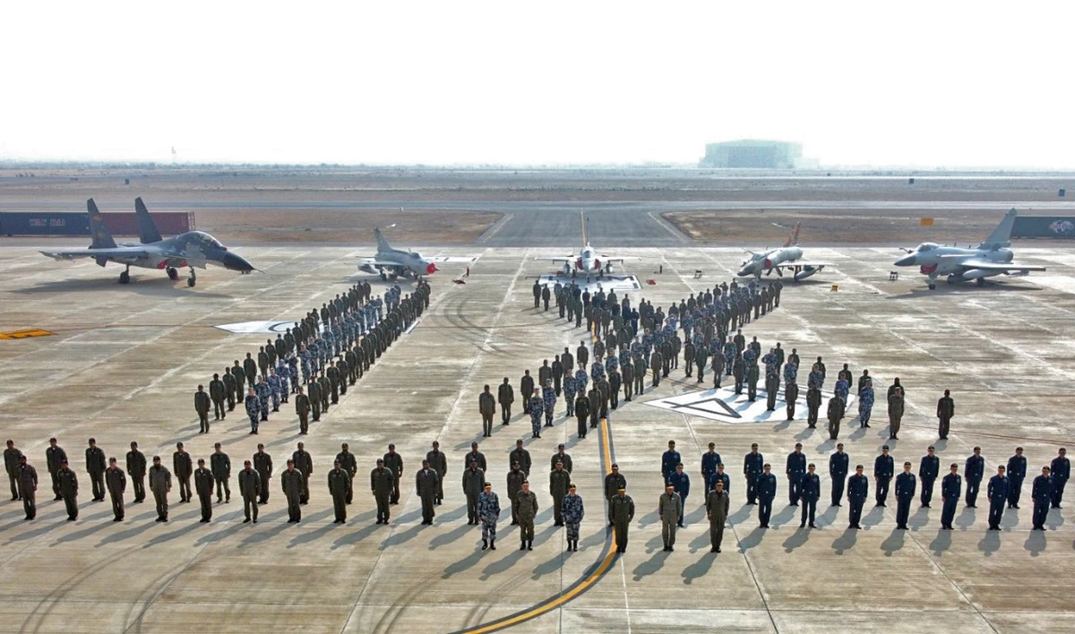Pakistan Air Force (PAF) Air Vice Marshal Waqas Ahmed Sulehri and China's People's Liberation Army Air Force (PLAAF) Maj. Gen. Sun Hong pose for a photograph with participants of the Shaheen-IX joint exercise at a PAF operational air base on Dec. 9, 2020. (Photo courtesy: PAF/File)
