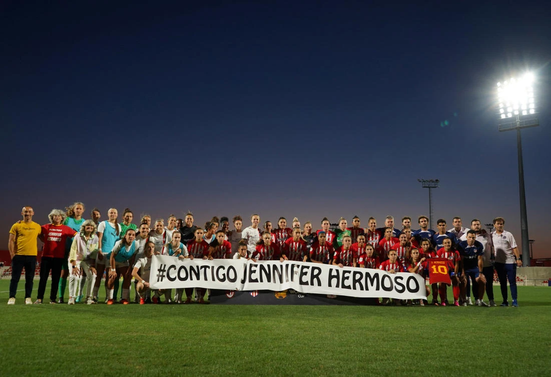 Atletico Madrid and AC Milan players and staff hold a banner in support of Spain’s Jennifer Hermoso before their match The Women’s Cup at Centro Deportivo Wanda Alcala de Henares, Alcala de Henares, Spain on Aug. 26, 2023. (Reuters)