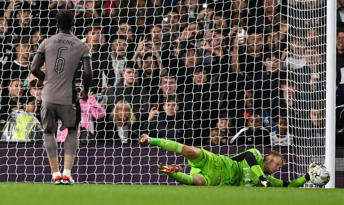 Fulham's Slovakian goalkeeper Marek Rodak saves the penalty shot by Tottenham Hotspur's Colombian defender Davinson Sanchez during the English League Cup match between Fulham and Tottenham Hotspur at Craven Cottage stadium, in London, on Tuesday. (AFP)