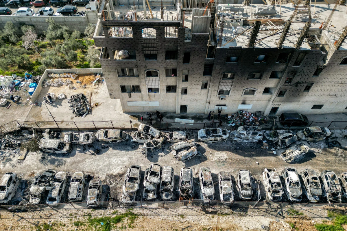 This picture taken on February 27, 2023 shows an aerial view of a scrapyard where cars were torched overnight during an attack by Jewish settlers on the Palestinian town of Huwara near Nablus in the occupied West Bank. (AFP/File)