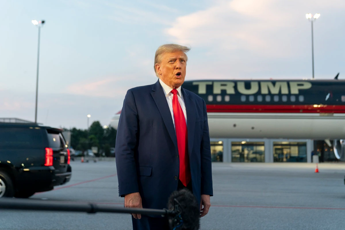 Former President Donald Trump speaks with reporters before departure from Hartsfield-Jackson Atlanta International Airport on Aug. 24, 2023, in Atlanta. Trump has pleaded not guilty and waived arraignment in the case accusing him and others of illegally trying to overturn the results of the 2020 election in Georgia. (AP Photo/File)