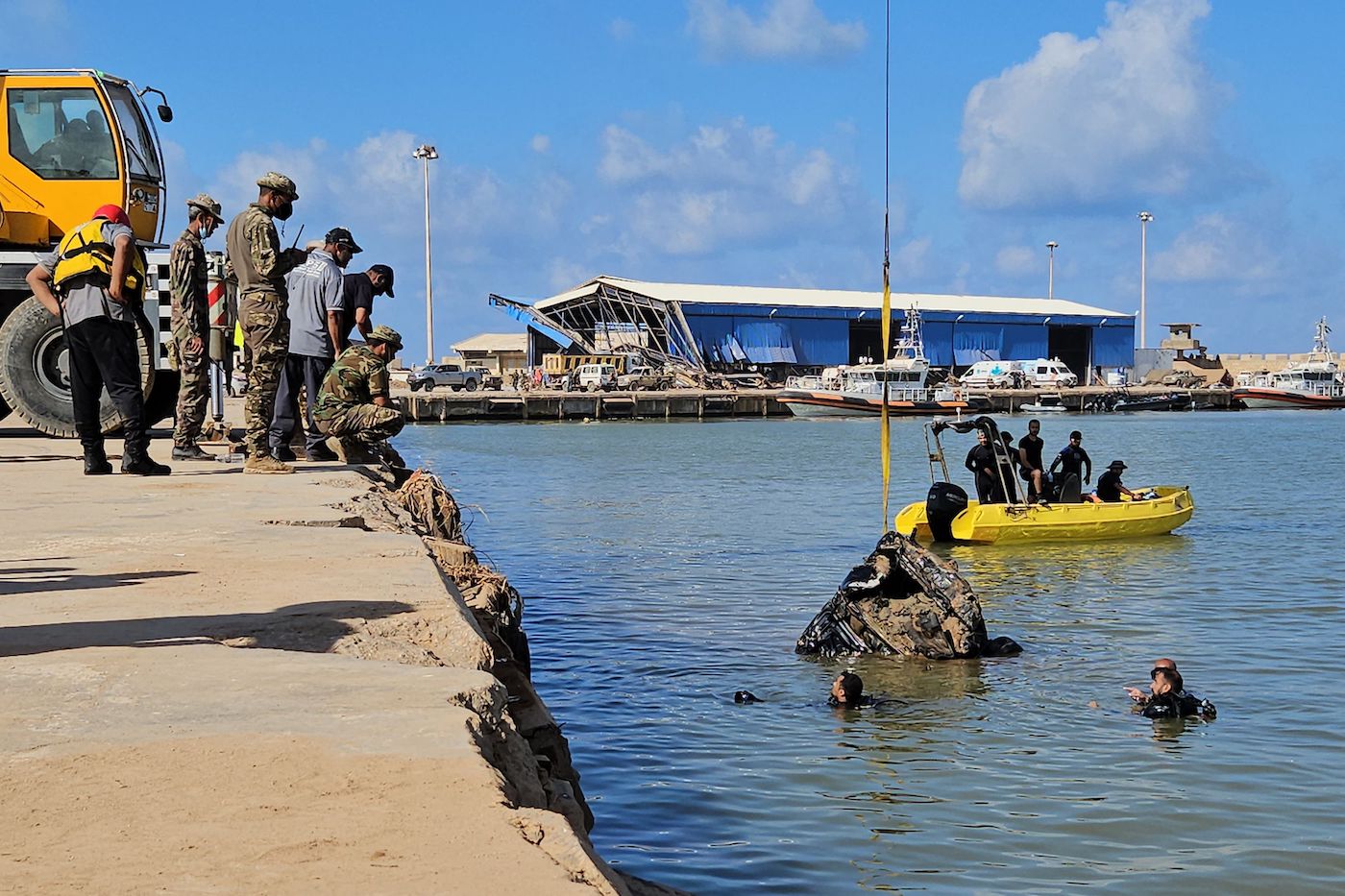 A car that was washed into the sea during the Sep. 10 flood, is pulled out of the water, at the port of Libya’s city of Derna.