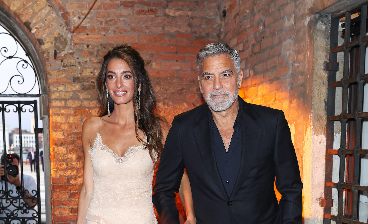 Amal wore a blush lace dress that featured a tulle overskirt by Christian Dior. (Getty Images)