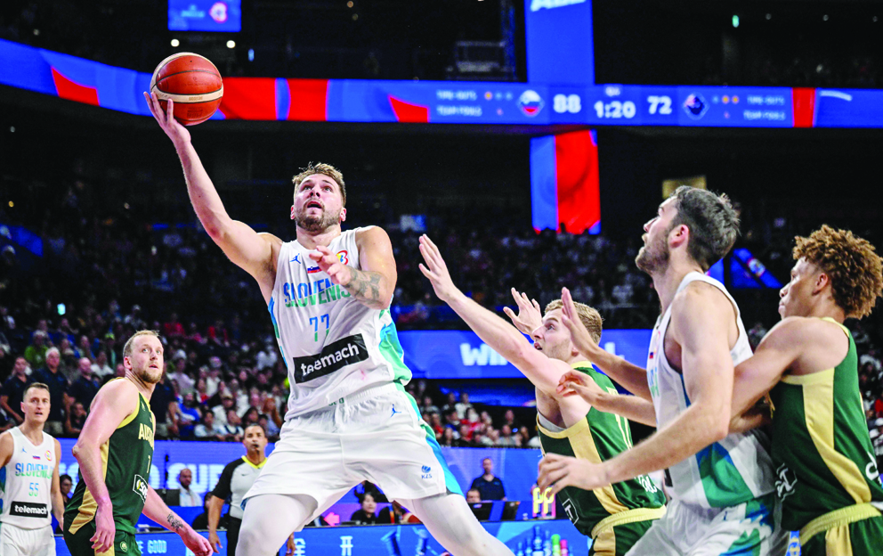 Slovenia’s Luka Doncic, center, drives to the basket during the FIBA Basketball World Cup Group K match between Slovenia and Australia at Okinawa Arena in Okinawa on Friday. (AFP)