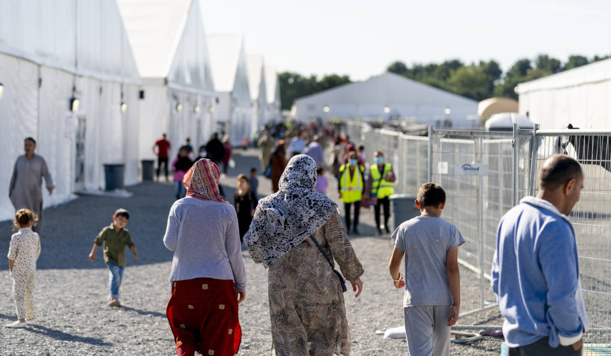 Afghan refugees walk through an Afghan refugee camp at Joint Base McGuire Dix Lakehurst, N.J., on Sept. 27, 2021. (AP)