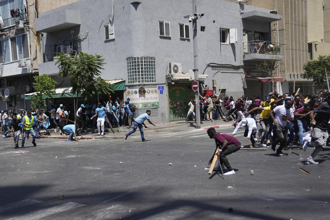 Anti-Eritrean government activists, left, clash with supporters of the Eritrean government, in Tel Aviv on Sept. 2, 2023. (AP)