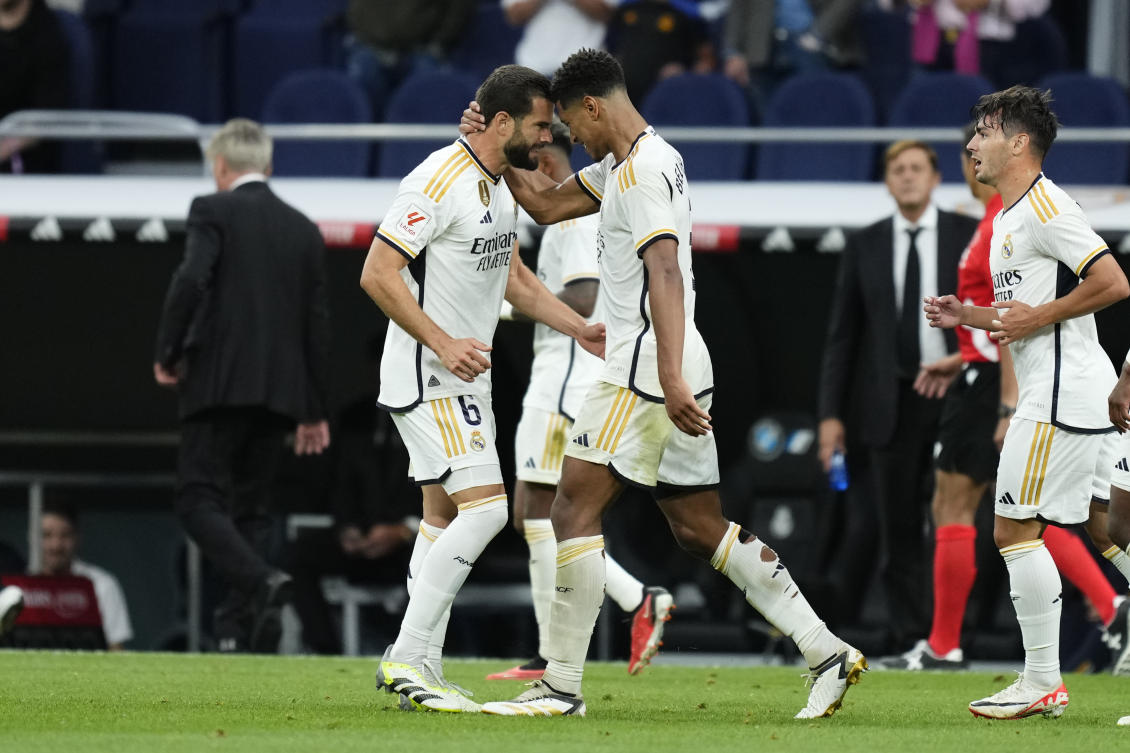 Real Madrid’s Jude Bellingham is congratulated after scoring his side’s 2nd goal by teammate Nacho during their Spanish La Liga against Getafe at the Santiago Bernabeu stadium in Madrid on Sept. 2, 2023. (AP)