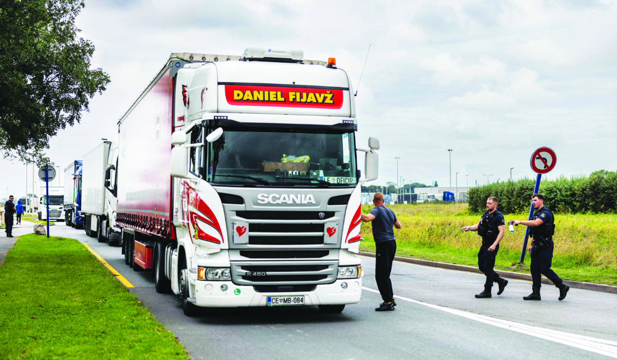 Police officers search for migrants near a lorry in Marck, northern France. Authorities were combing the land and sky to stop people heading for the English coast. (AFP file photo)