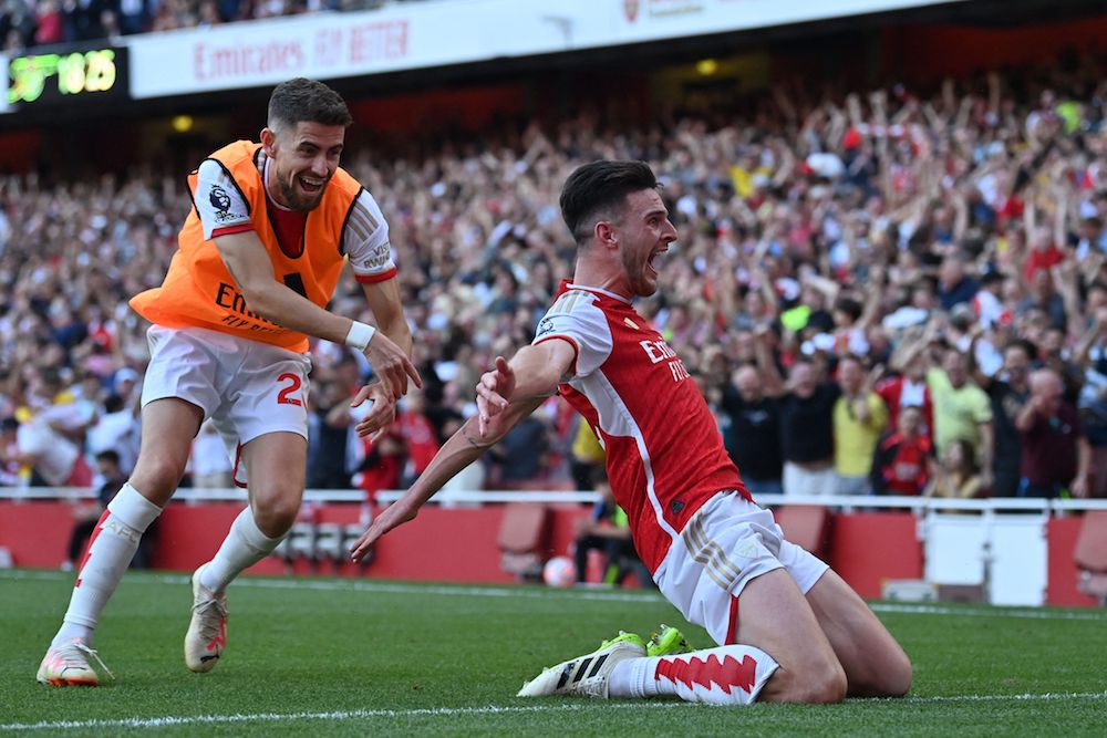 Arsenal's English midfielder #41 Declan Rice celebrates with Arsenal's Italian midfielder #20 Jorginho (L) after scoring their late second goal during the English Premier League football match between Arsenal and Manchester United at the Emirates Stadium. (AFP)