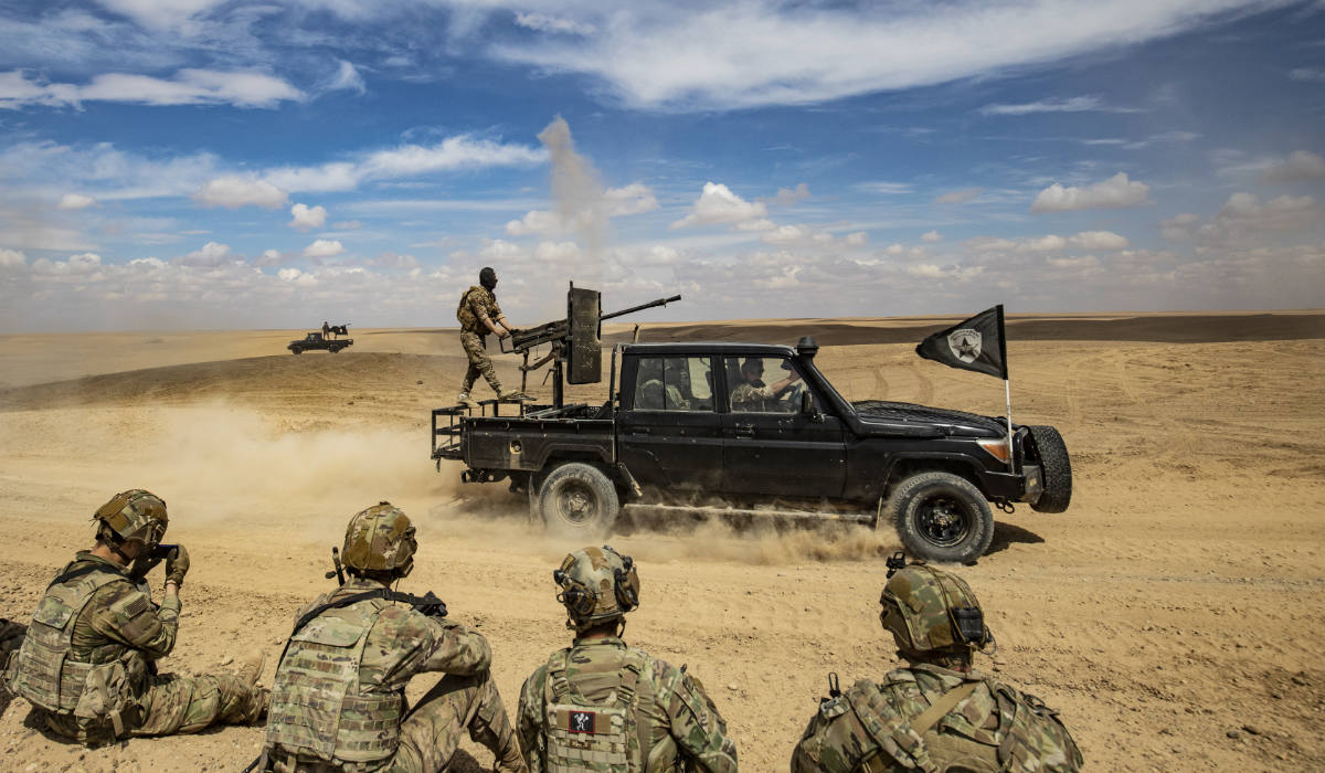 Troops from the Syrian Democratic Forces (SDF) Special Operations and the US-led anti-terrorist coalition, take part in heavy-weaponry military exercises in the countryside of Deir Ezzor in northeastern Syria, on March 25, 2022. (AFP)