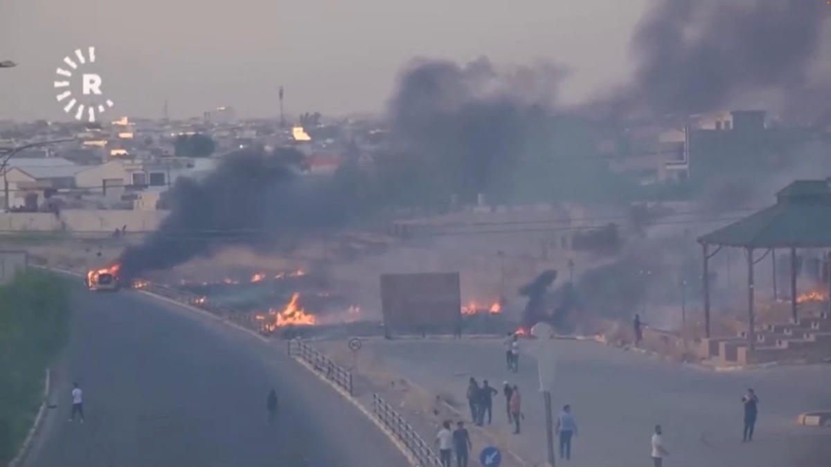 Fires burn as protesters take to the streets during clashes between ethnic groups in Kirkuk (Reuters)