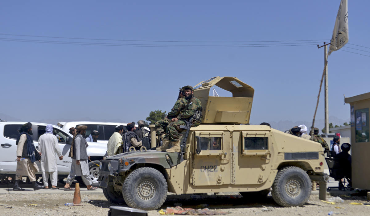 Members of Taliban wait to enter the former US military base to celebrate the first anniversary of the withdrawal of US-led troops from Afghanistan, in Bagram on August 31, 2022. (AFP)
