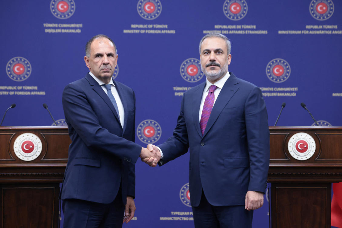 Turkish Foreign Minister Hakan Fidan shakes hands with his Greek counterpart George Gerapetritis during a press conference in Ankara (REUTERS)