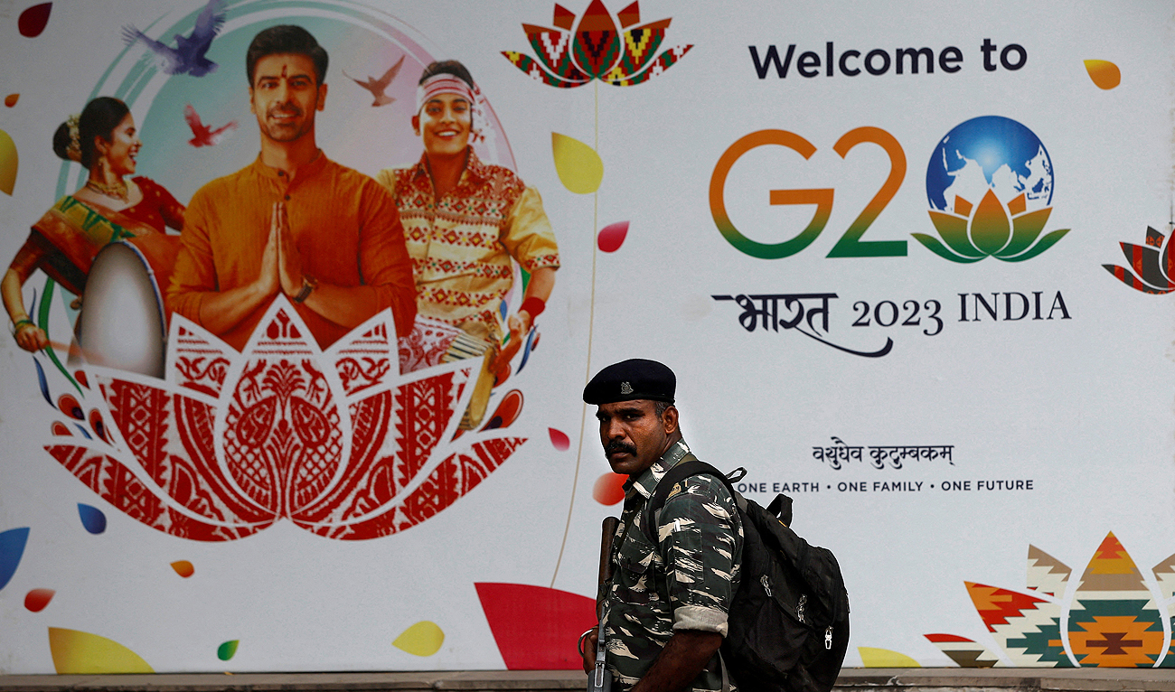 A Central Reserve Police Force personnel patrols a road next to a hoarding ahead of the G20 Summit in New Delhi, India, September 6, 2023. (REUTERS)