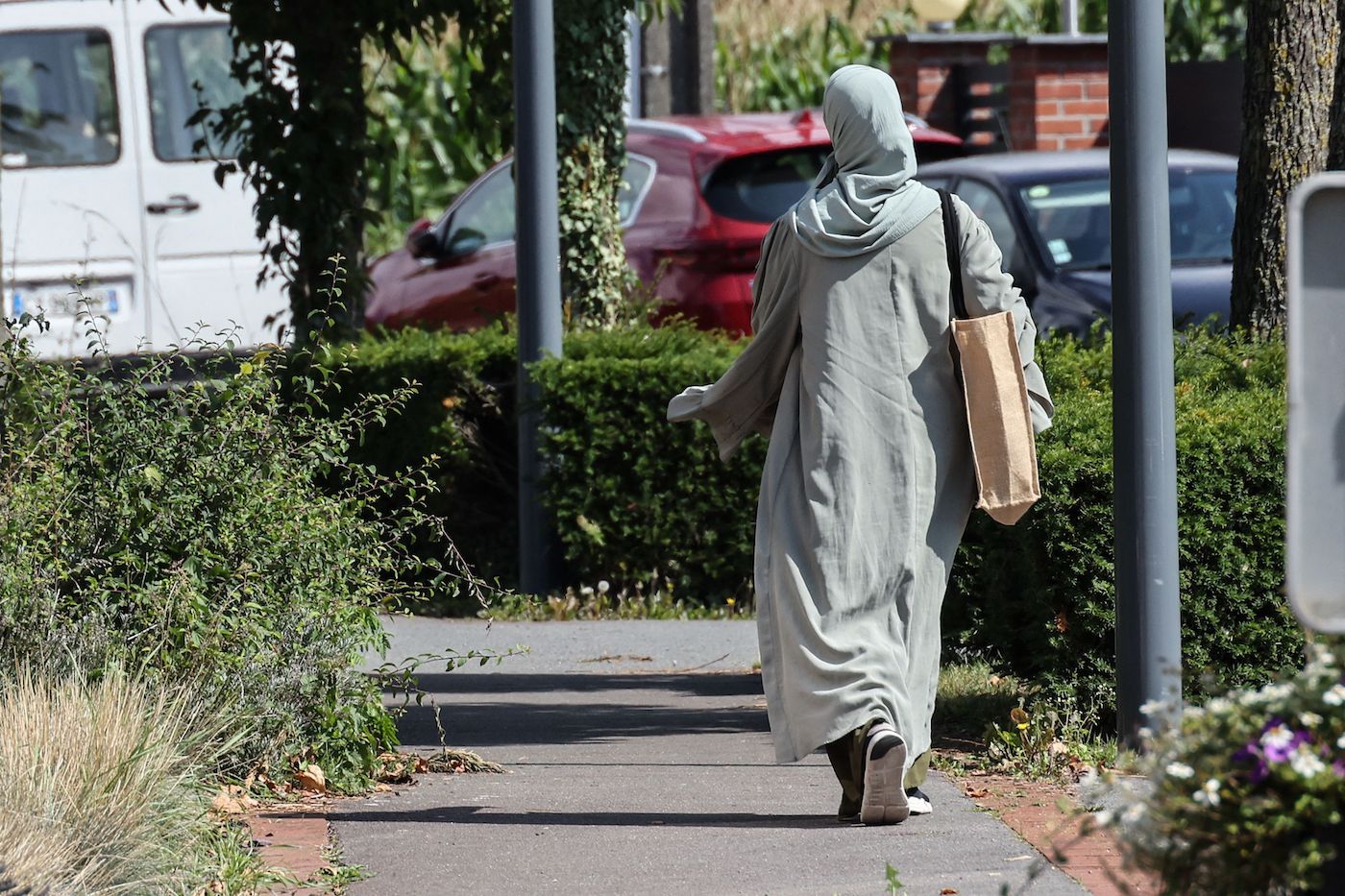 A woman wearing an abaya walks through the streets of Lille, northern France. (File/AFP)