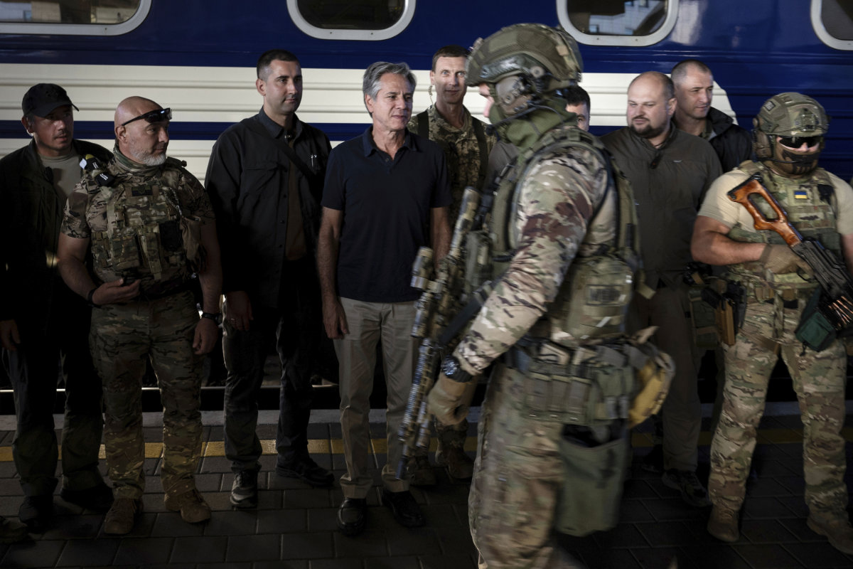 US Secretary of State Antony Blinken, center, stands next to Ukrainian security forces before departing a train station in Kyiv on Sept. 7, 2023. (Pool via AP)