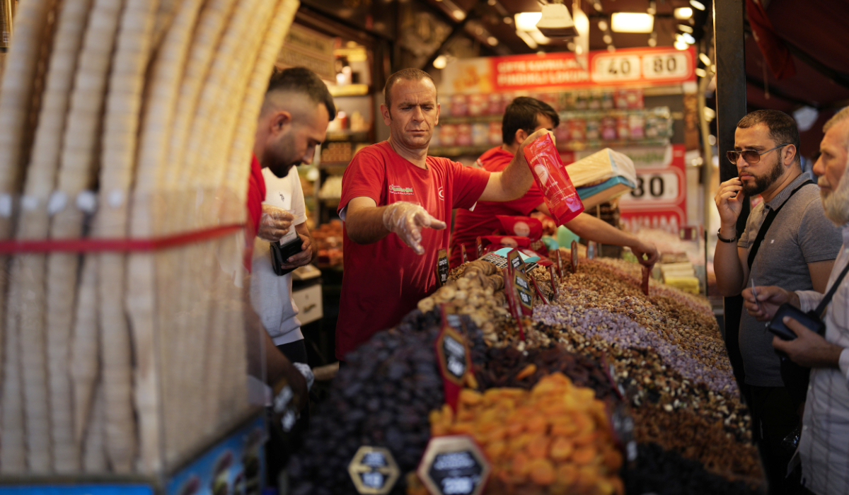Food shop sellers attend clients in a street market at Eminonu commercial district in Istanbul, Turkey, Wednesday, Sept. 6, 2023. (AP)