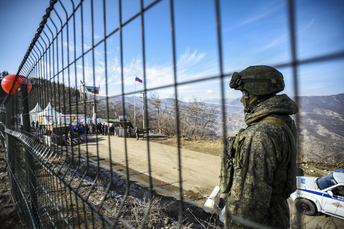 A Russian peacekeeper guards the Lachin corridor, the Armenian-populated breakaway Nagorno-Karabakh region's only land link with Armenia, as Azerbaijani environmental activists protest against what they claim the illegal mining, on December 27, 2022. (AFP)