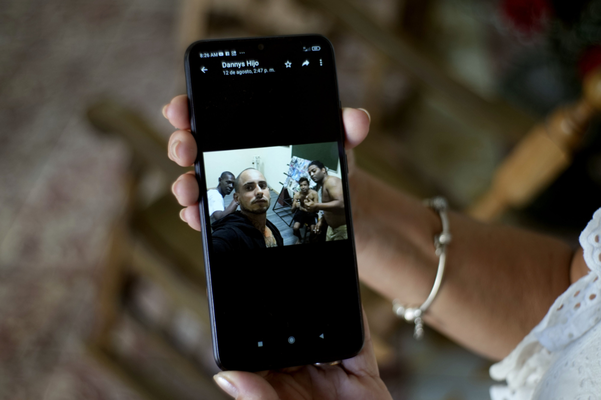 Marilin Vinent shows a photo of her son Dannys Castillo dressed in military fatigues in an Aug. 22 message from her son that reads in Spanish, "I'm already entangled", during an interview at her home in Havana, Cuba, on Sept. 8, 2023. Vinent said that her son and other Cubans traveled at the end of July to Russia after being promised work in a construction job, but that he was one of the Cubans recruited to fight for Russia in Ukraine. (AP Photo/Ramon Espinosa)